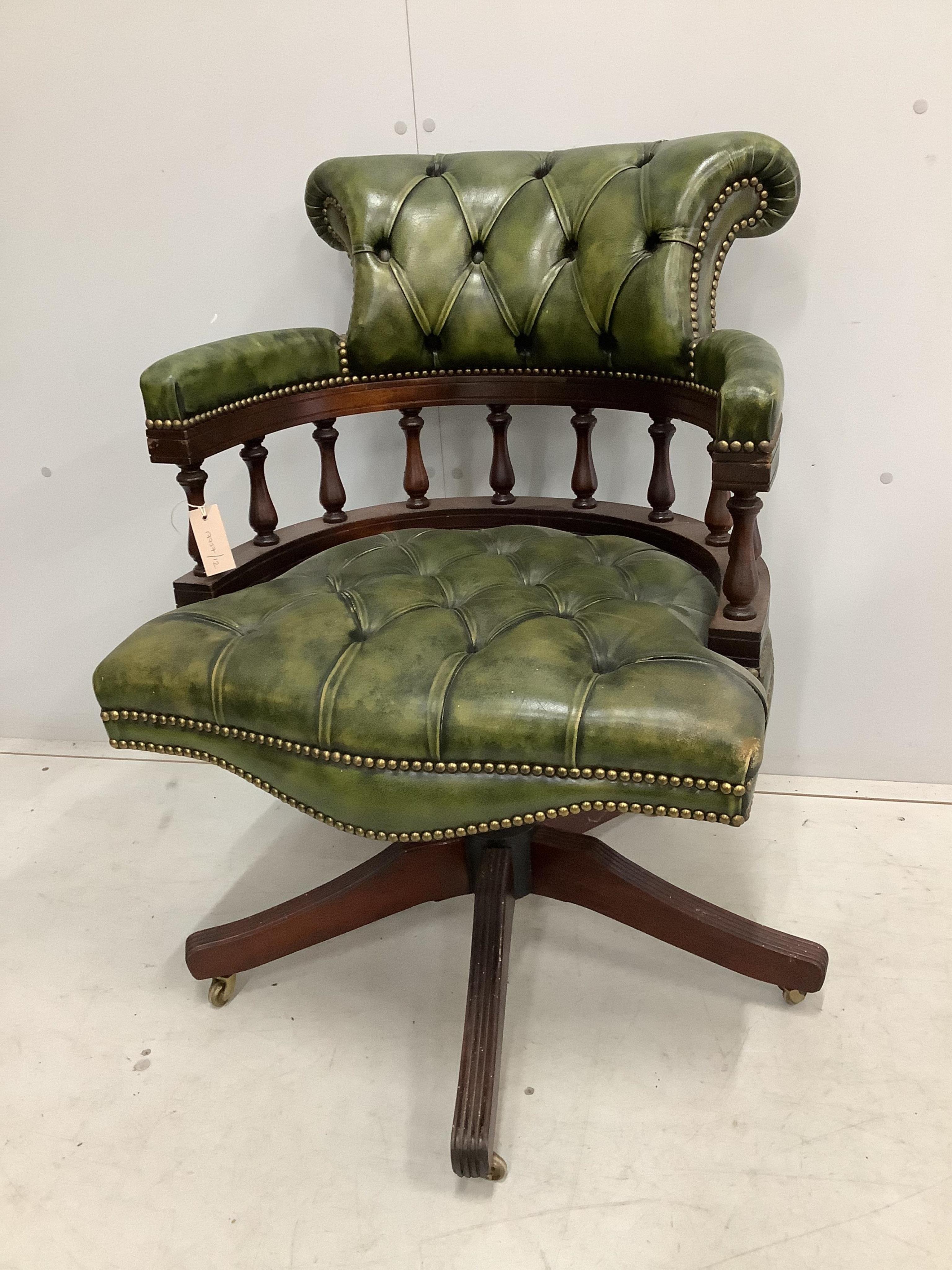 A reproduction Victorian style buttoned green leather swivel desk chair, width 63cm, depth 56cm, height 88cm